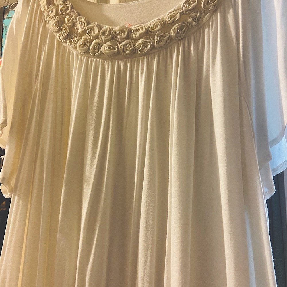 Beautiful flowing top with floral neckline